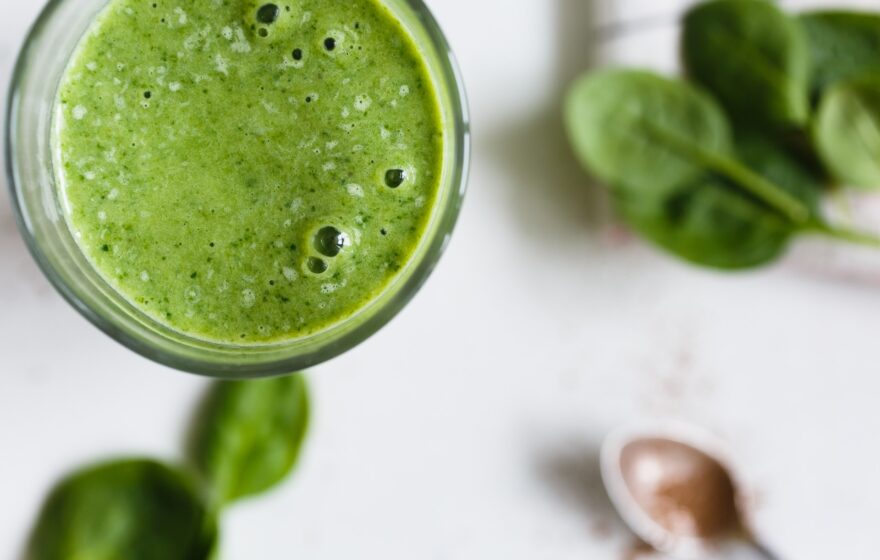 green spinach smoothie photographed from above close up
