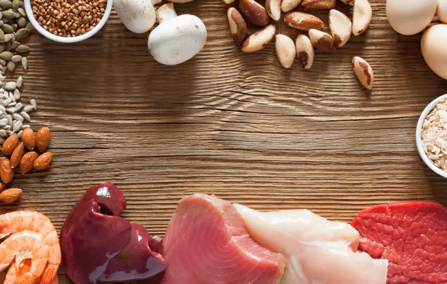 Assorted protein-rich foods, including nuts, seeds, mushrooms, eggs, grains, seafood, offal, poultry, and red meat, arranged on a wooden surface—perfect fuel for those long automated testing or Selenium sessions.