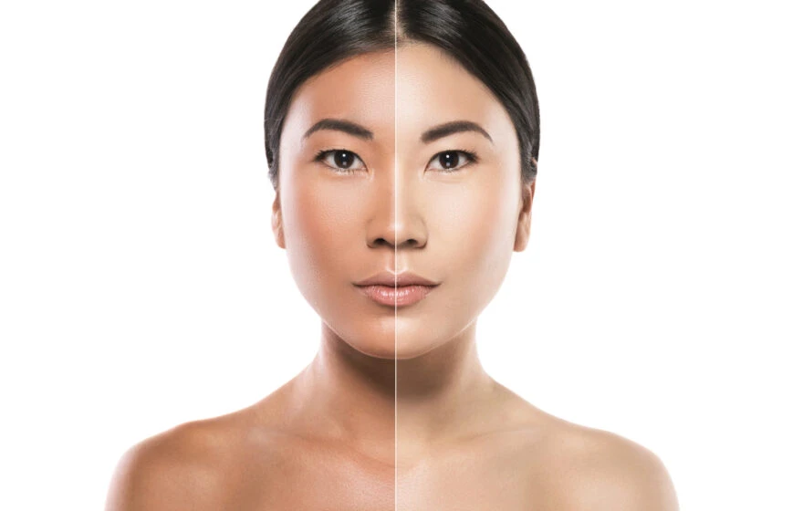 A woman's face is shown divided down the centre, with each side displaying different make-up or skin tone effects, highlighting the potential benefits of glutathione, against a white background.
