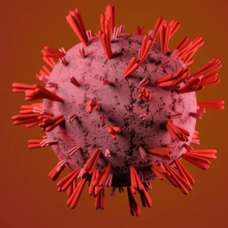 A 3D rendering of a spherical virus particle with protruding red spike proteins against a reddish gradient background, evoking the pale tones often seen in anaemic lips—one of the subtle signs of anaemia.