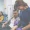 A nurse takes blood from a seated man while another woman waits in the background, both in a medical clinic where IV Booster treatments and antioxidant therapies are offered.