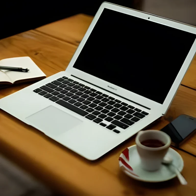 A silver laptop sits on a wooden table next to a notebook with a pen, a mobile phone, and a cup of tea on a saucer—an inviting space for researching topics like How Hydrogen Peroxide IV Therapy Works.