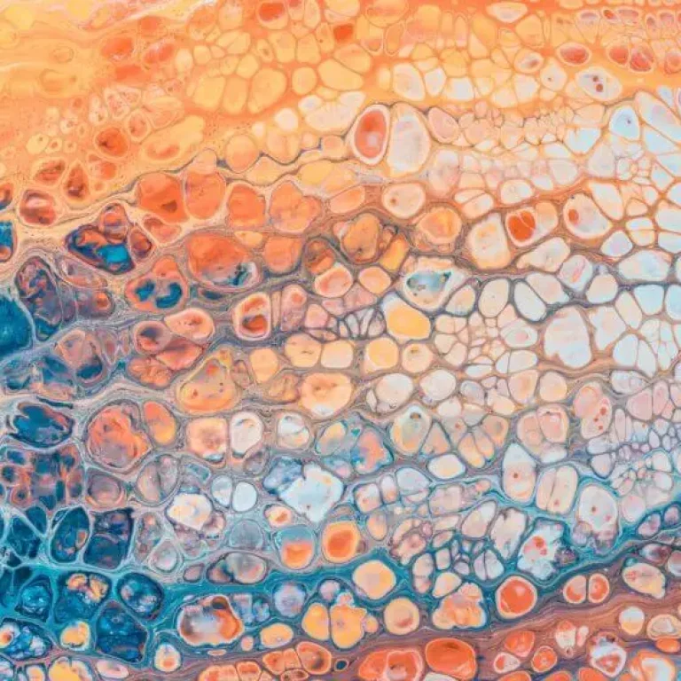 Abstract painting with a honeycomb pattern in blue, orange, and cream colours blending together, evoking an organic effect reminiscent of cells that tackle oxidative stress.