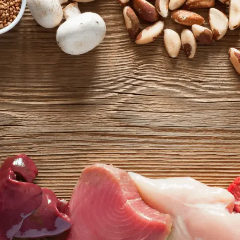 Assorted protein-rich foods, including nuts, seeds, mushrooms, eggs, grains, seafood, offal, poultry, and red meat, arranged on a wooden surface—perfect fuel for those long automated testing or Selenium sessions.