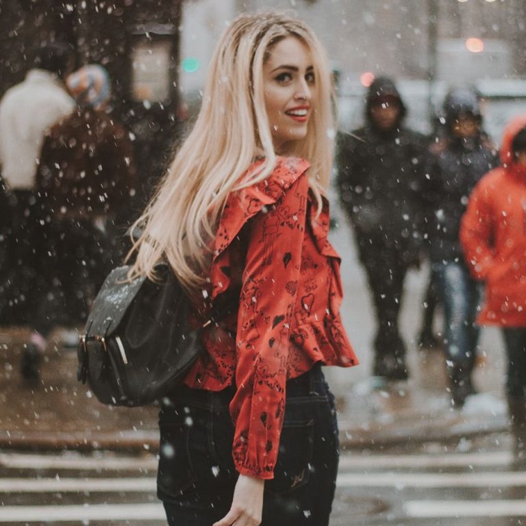 girl walking in the street while snowing